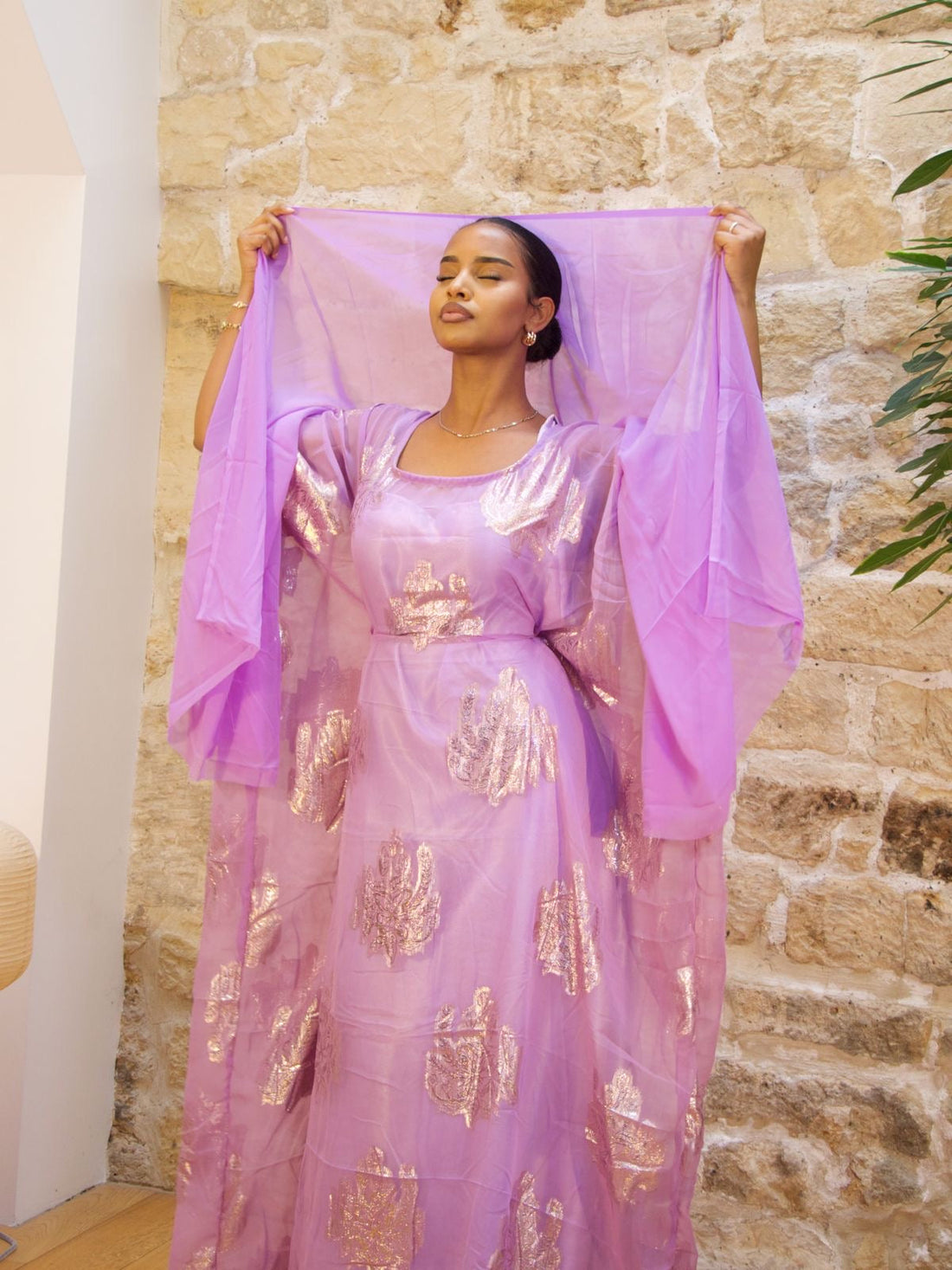 Woman wearing a purple and gold Somali Dirac with matching shawl – Maison Kemeti